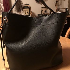 Carlos Santana black tote with striped interior.